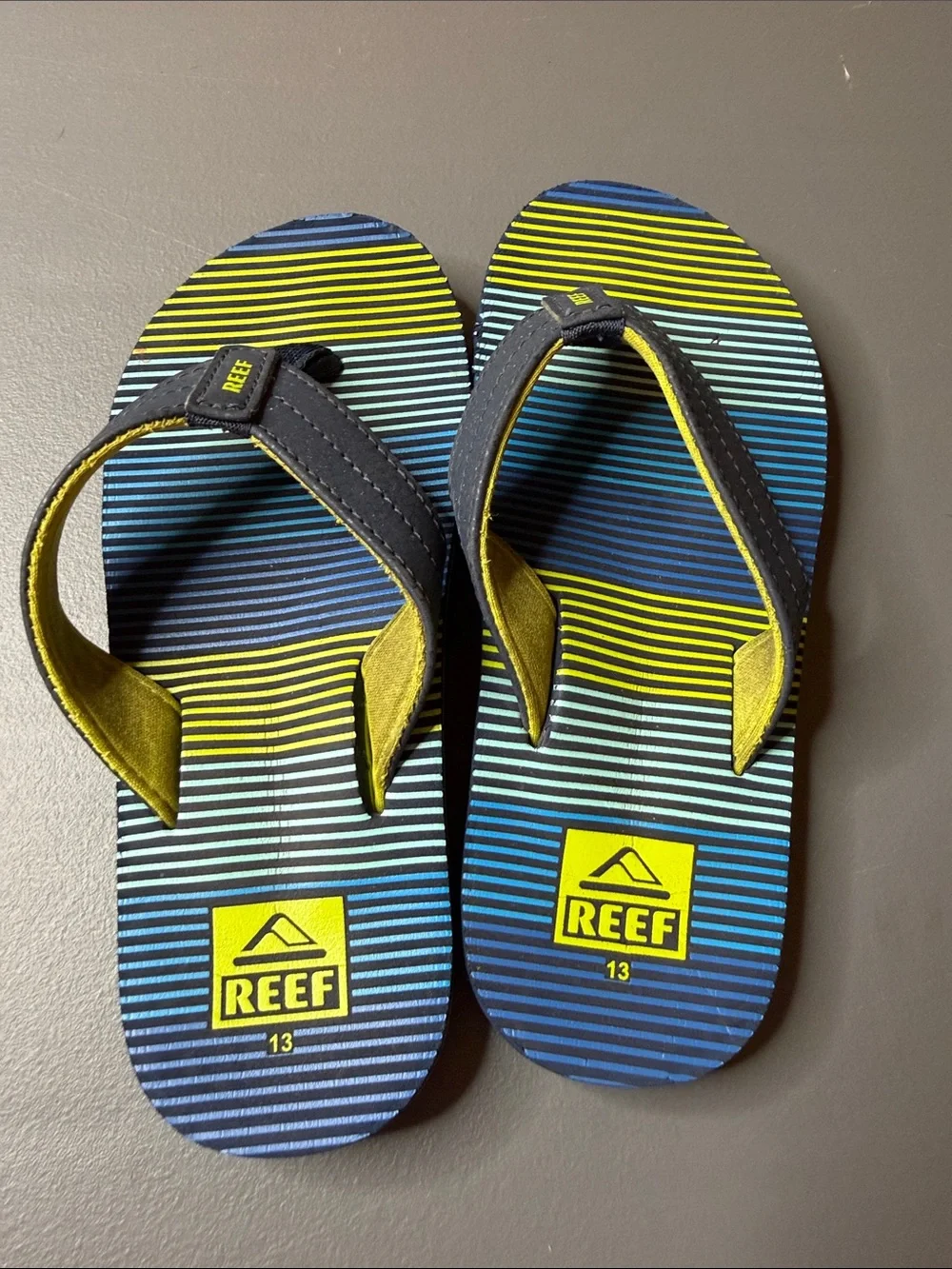 Kid’s Reef Blue & Yellow Striped Flip Flops. Size: 13